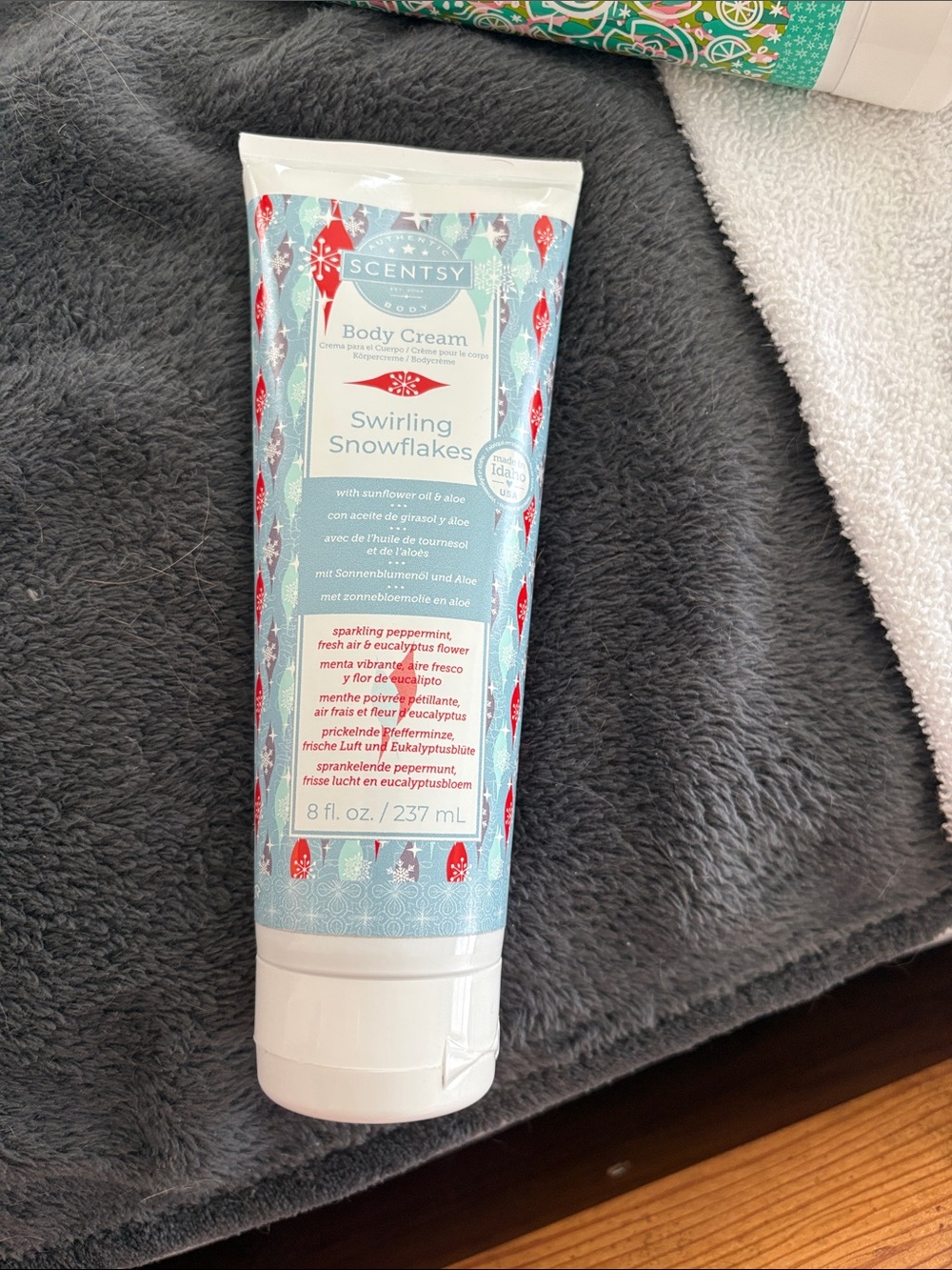 Scentsy Swirling Snowflakes Body Cream - Light Blue with Red Accents